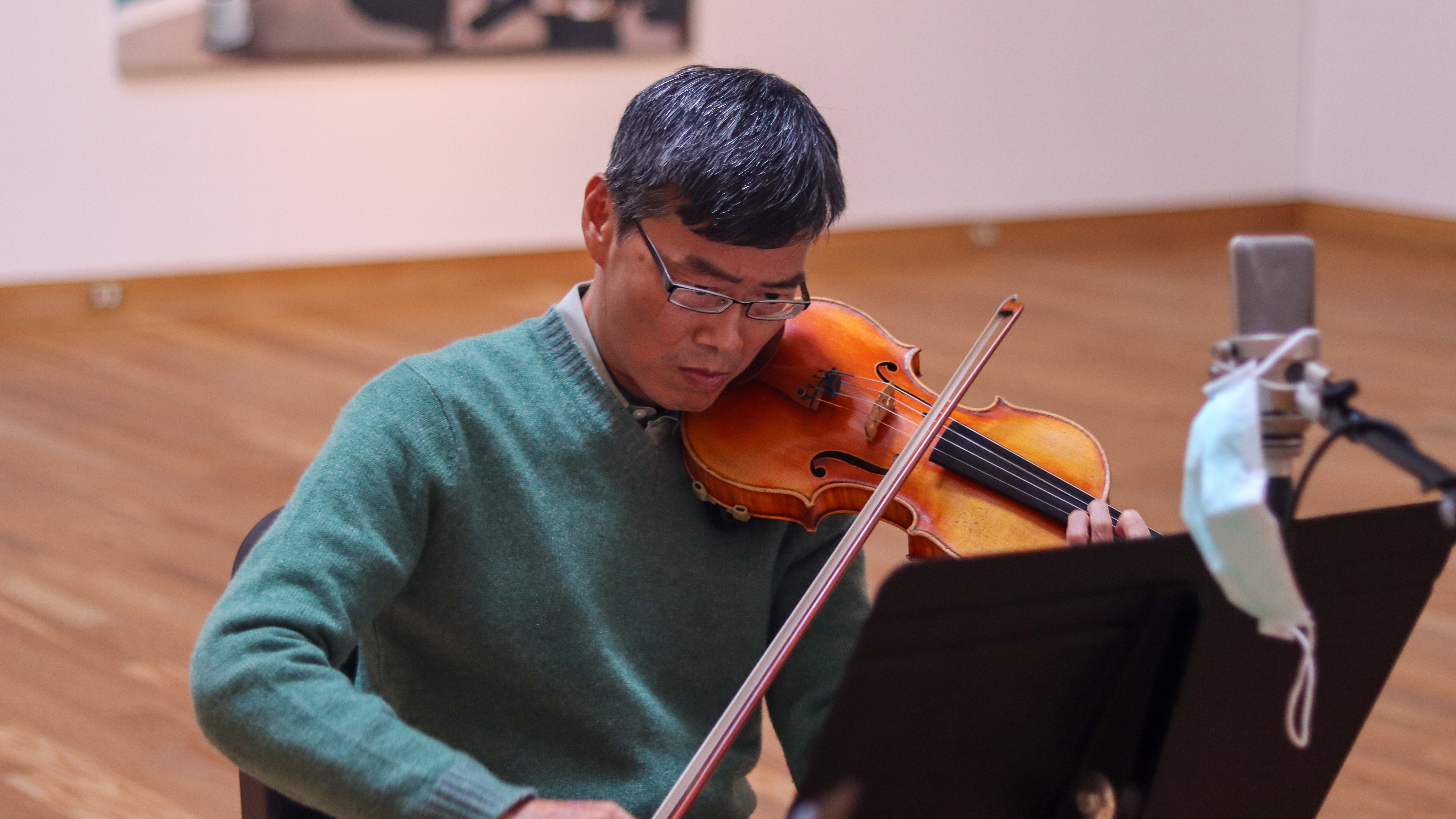 Taichi Chen tunes before performing as Violin II in “String Quartet No.2 in D Major: III. Nocturne” by Alexander Borodin in Art + Medicine: Healthy Aging.